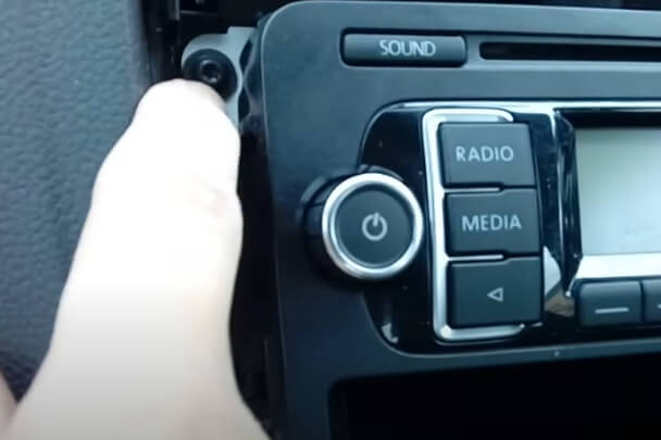 Showing screws behind plastic trim of VW radio